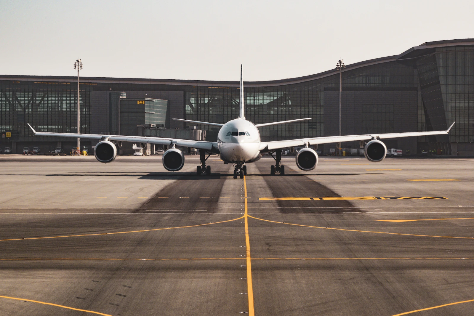 Commercial wide-body aircraft taxiing towards the terminal stand
