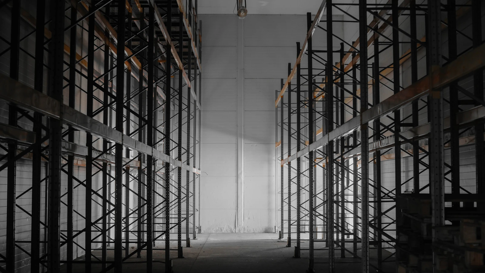 Steel pallet racking running the length of an organised component storage facility